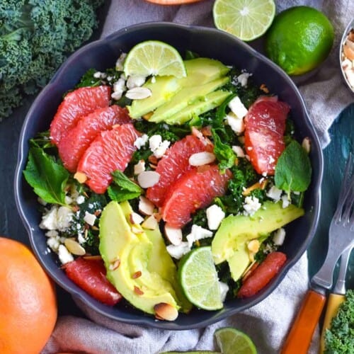 kale grapefruit salad in black bowl.