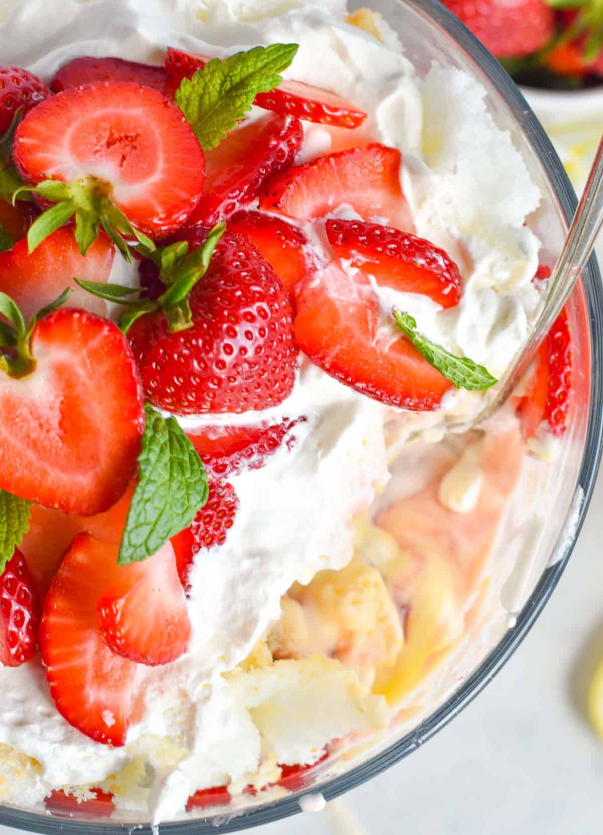 strawberry trifle with big scoop out of it.