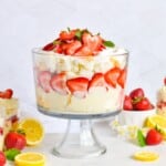 strawberry trifle layered with lemon mousse and angel food cake in glass trifle bowl.