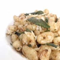 gnocchi with fired sage in a white bowl