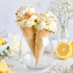 two ice cream cones with lemon pie ice cream in glass cup.