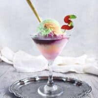 rainbow sherbet ice cream float in a martini glass on a silver tray