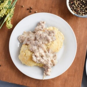 biscuits and sausage gravy on white plate.