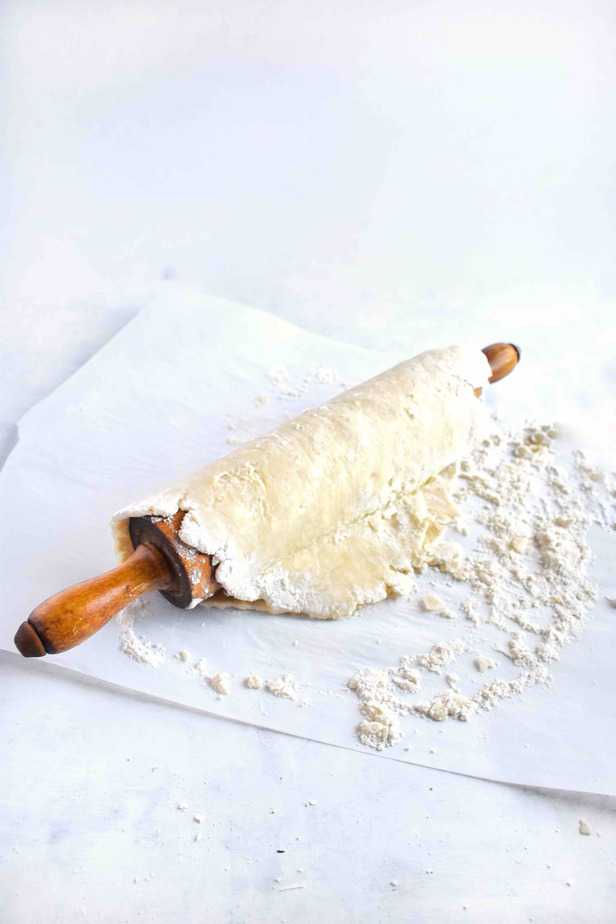 pie crust draped over rolling pin