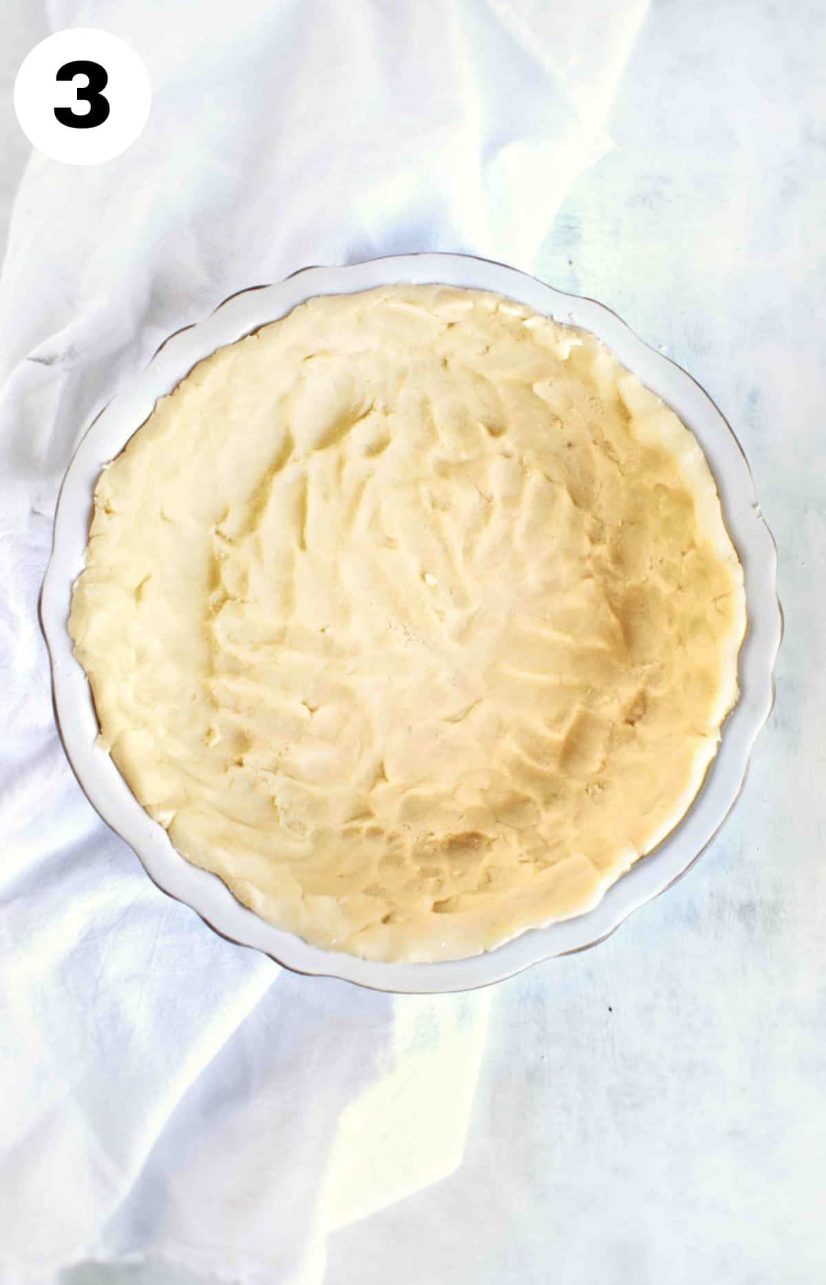 shortbread pie crust dough pressed into pie pan. 