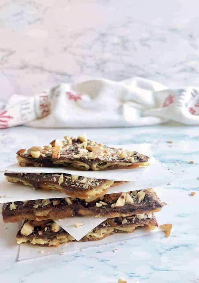 stack of soda cracker toffee pieces with parchment in between