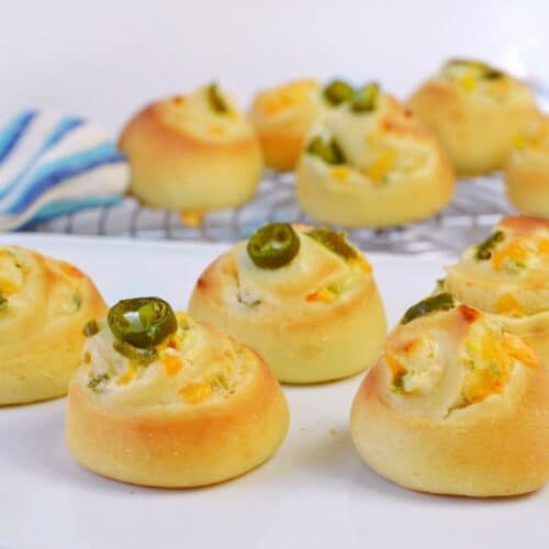 striped towel and baking rack with spiral rolls with jalapenos and cheese
