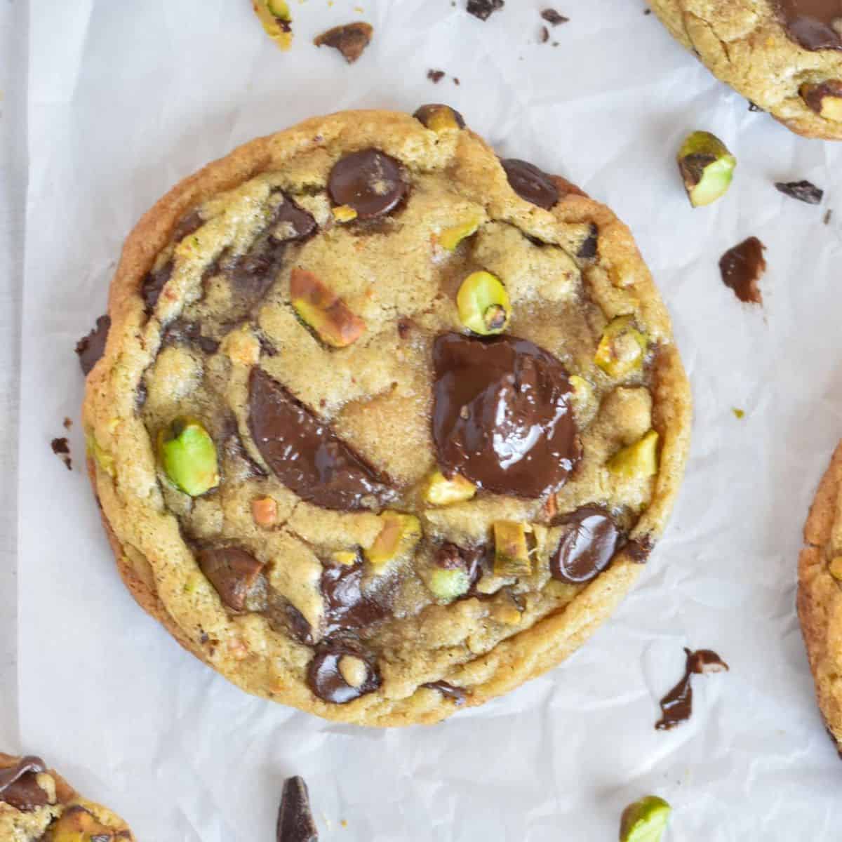 cookie with melty chocolate and pistachios on top.