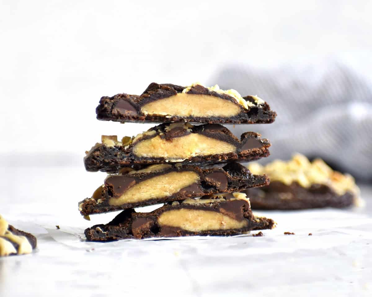 chocolate peanut butter stuffed cookies cut in half and stacked on each other.