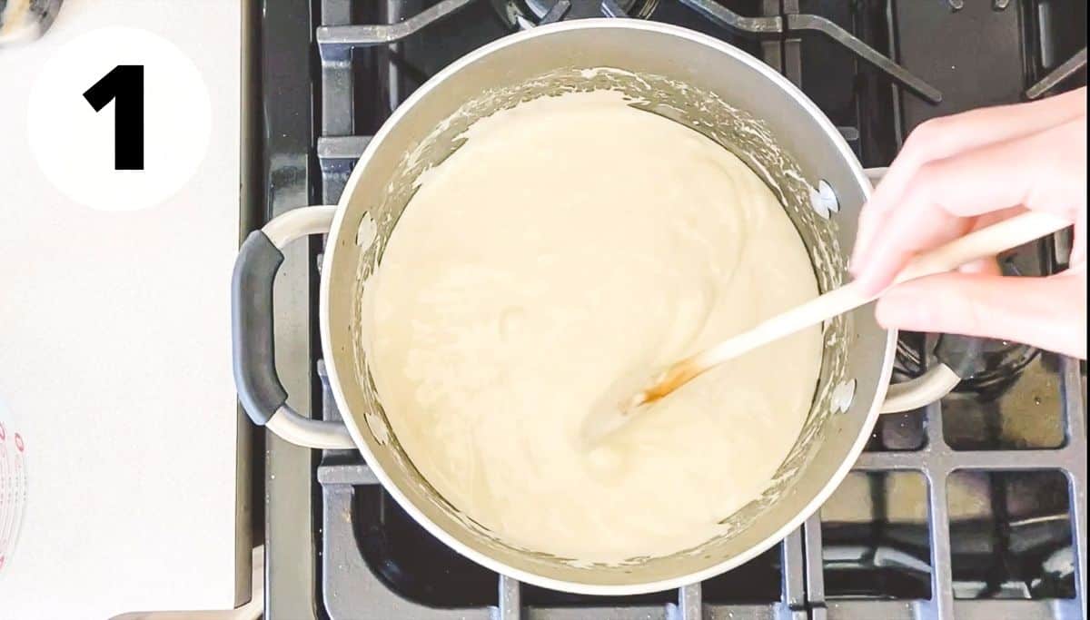 hand stirring pot of melted butter and marshmallows. 
