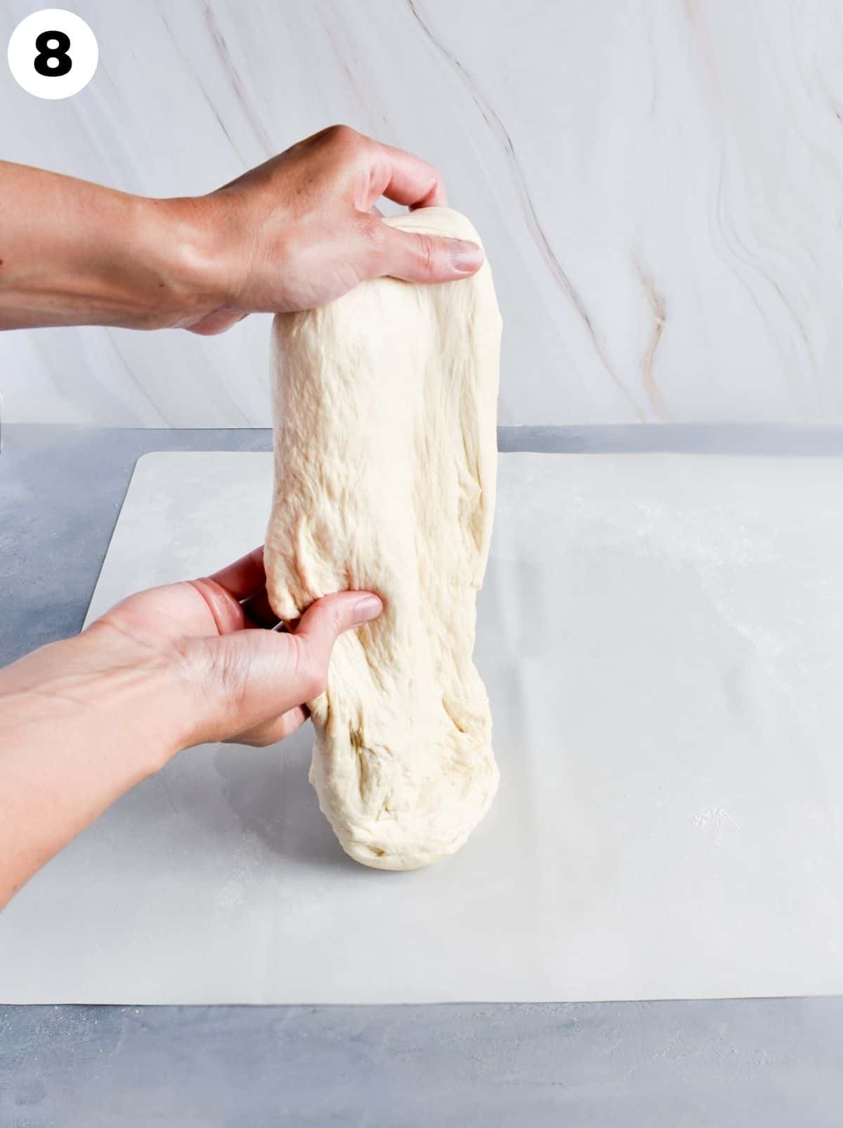 dough being hand stretched. 