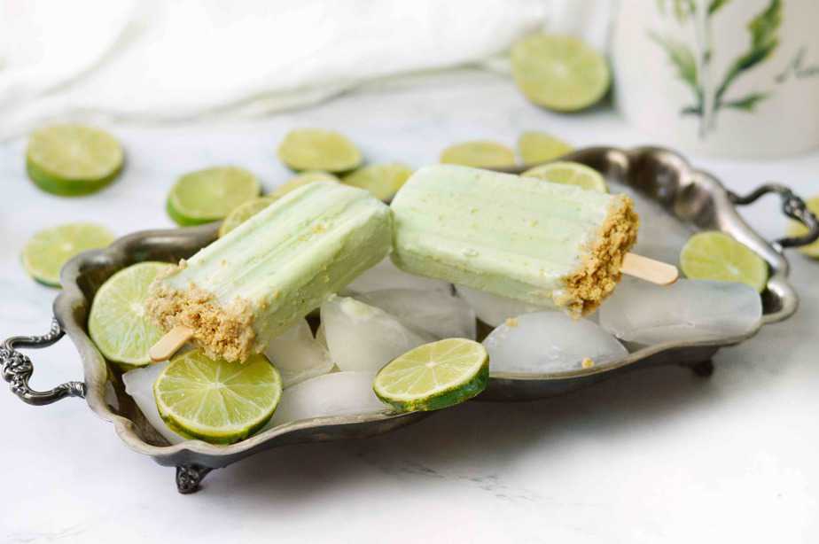 silver tray filled with ice and 2 key lime pie popsicles
