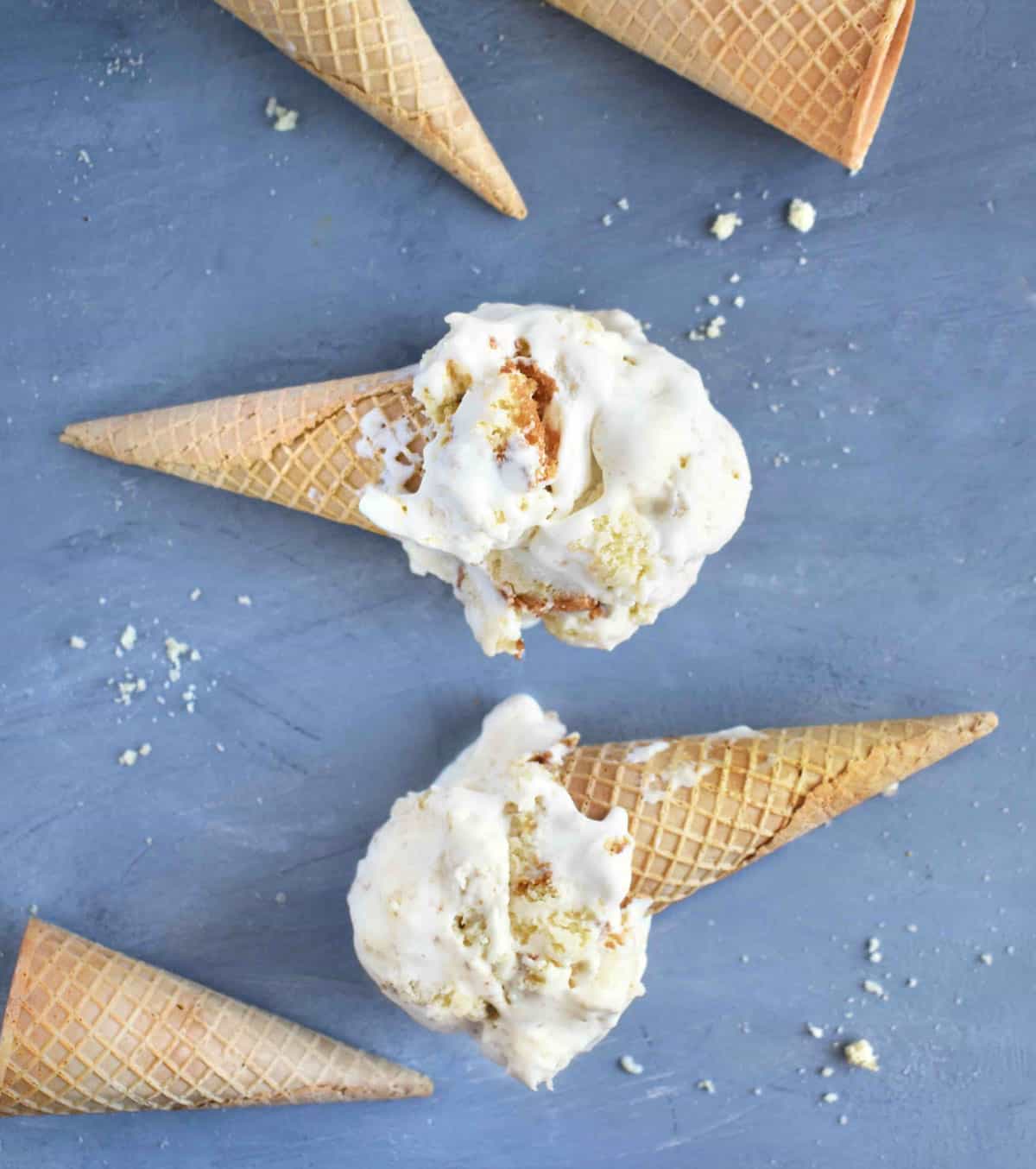 scoops of ice cream on cones on their sides. 