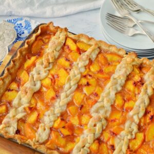 easy peach slab pie in a sheet pan with braided crust on top