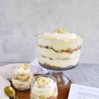 trifle bowl and small cups filled with banana pudding