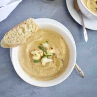 cauliflower soup with slice of bread on side