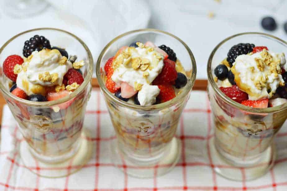Top view of 3 glasses filled with berry yogurt parfait