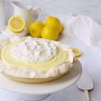 lemon cloud pie with white pitcher and lemons behind