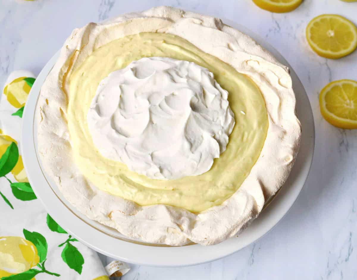 Full lemon angel pie on white platter.