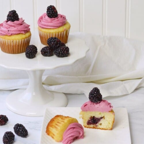 berry cupcakes on white cake platter