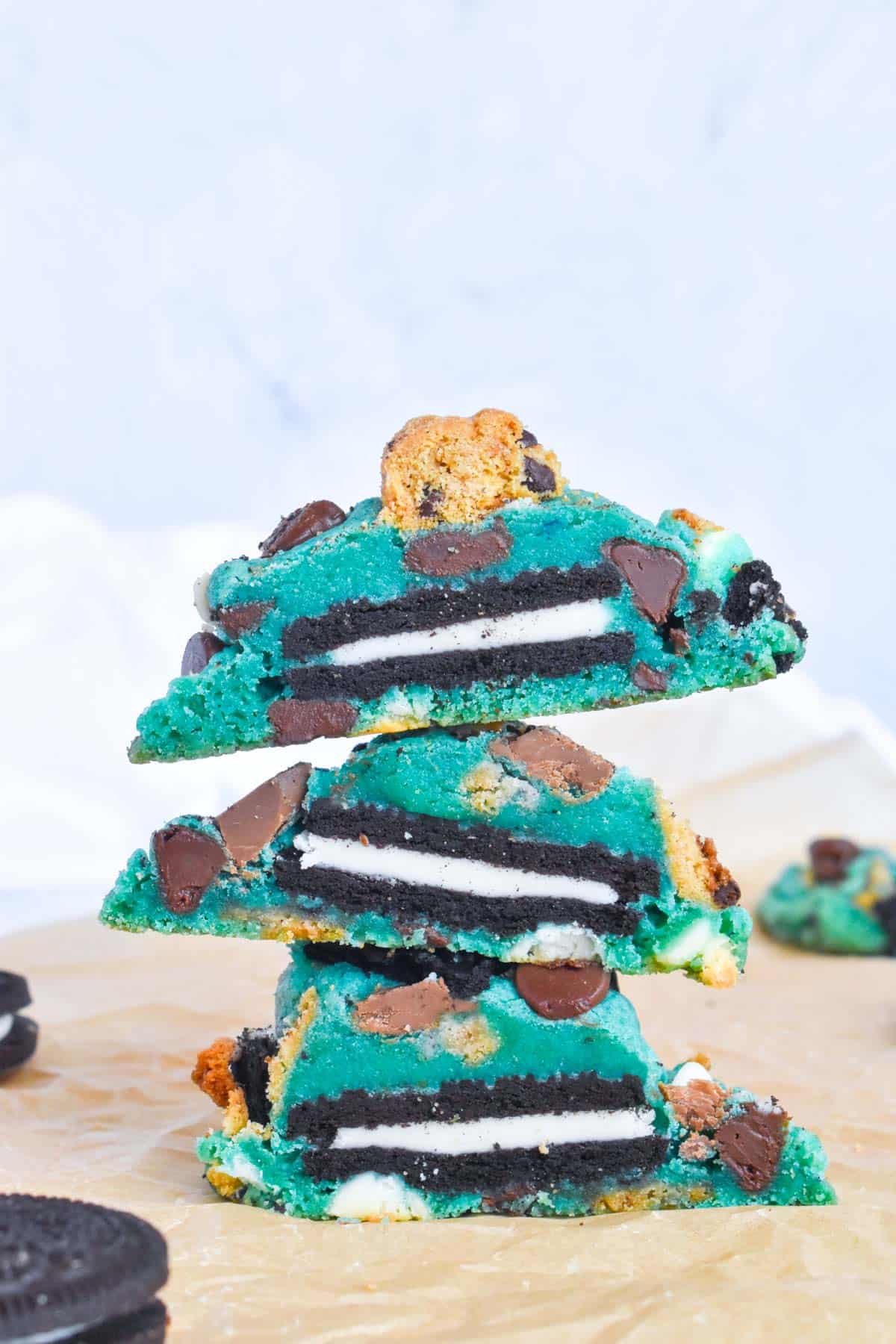 stack of 3 cookie monster cookies with oreos in center. 