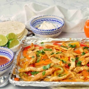 fajita meat and vegetables on a sheet pan.