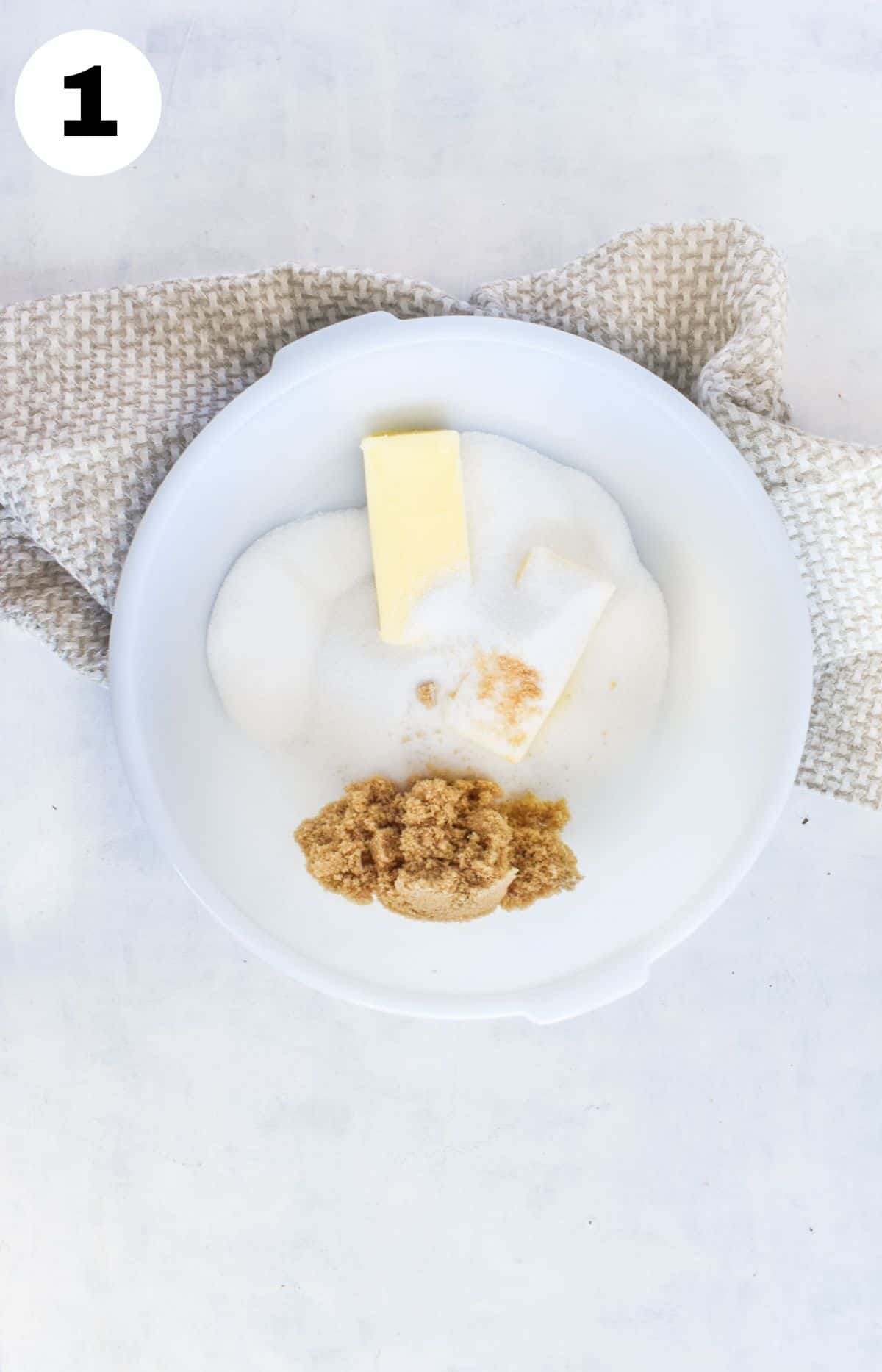 butter and sugars in white mixing bowls. 
