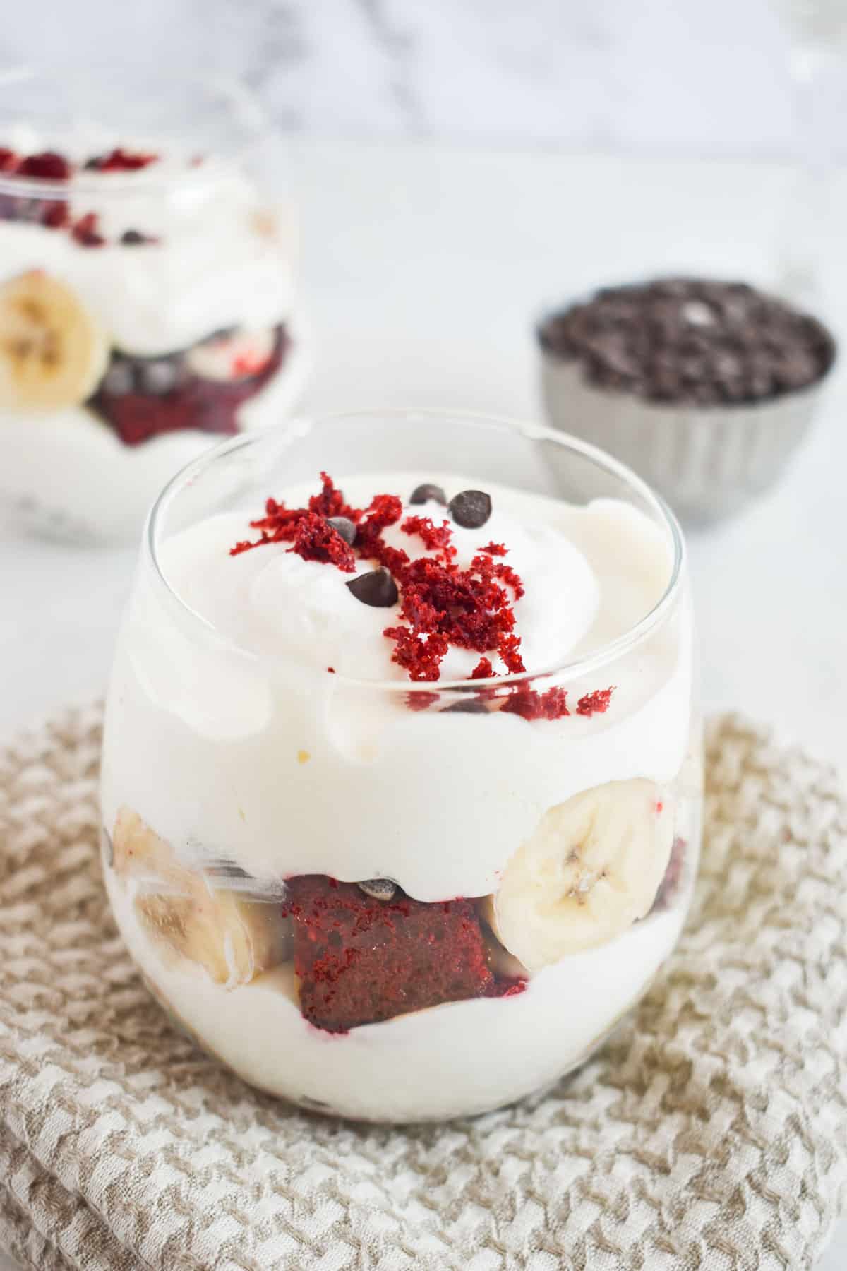 red velvet banana pudding layered in small glass cup. 