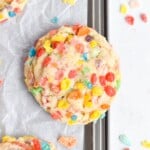 fruity pebble cookie on edge of baking sheet.