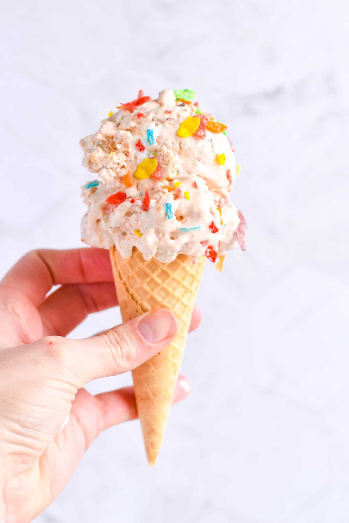 hand holding ice cream cone. 
