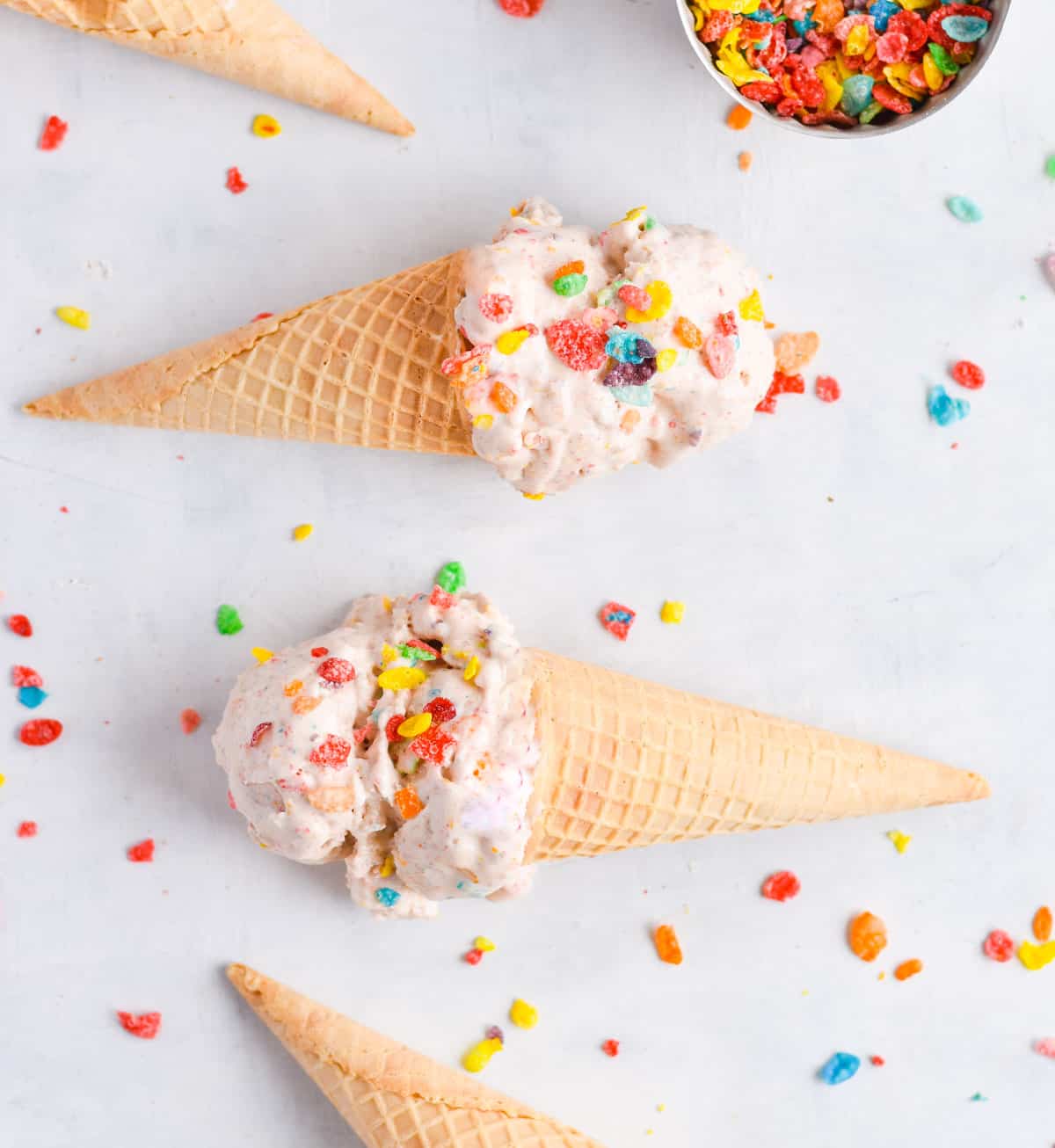 ice cream cones topped with ice cream on their sides. 
