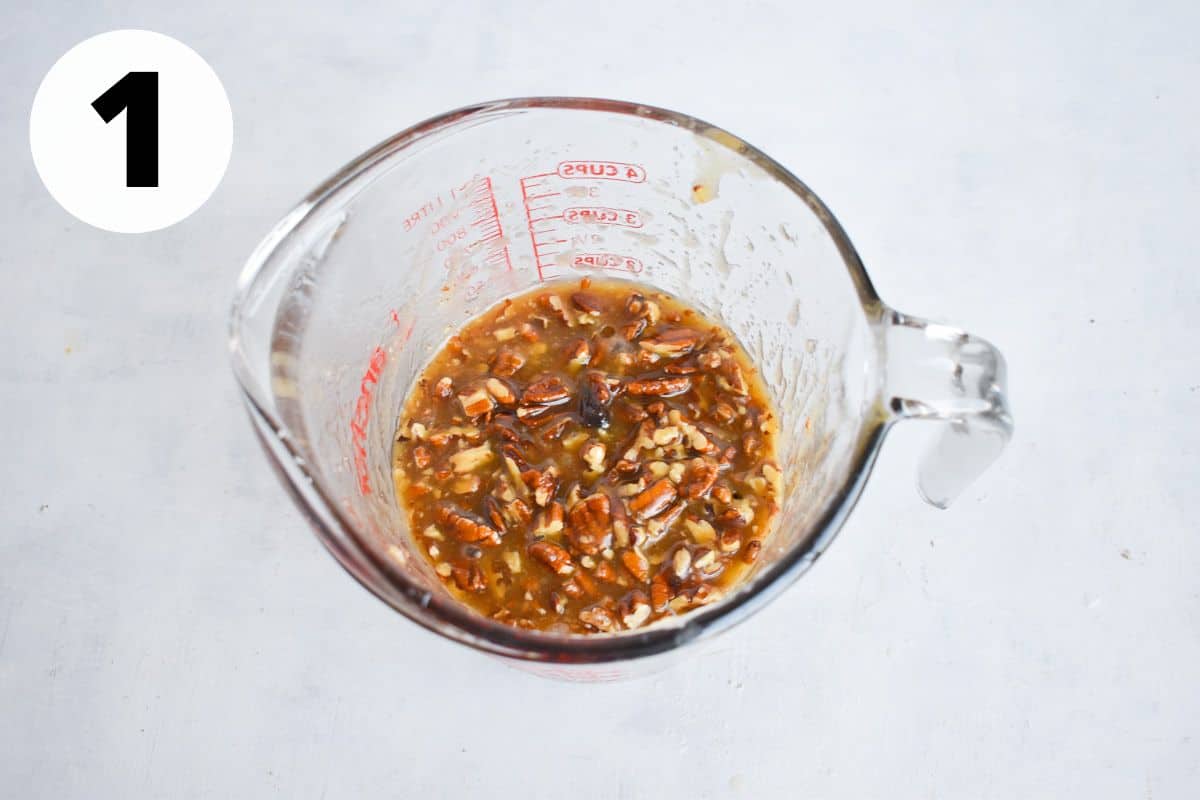 caramel pecan topping in glass measuring cup. 
