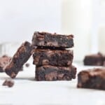 three brownies stacked on top of each other and one leaning against the pile.