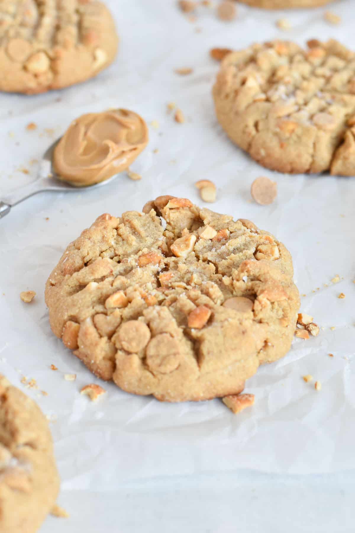 brown butter peanut butter cookie with spoonful of peanut butter behind it.