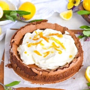 chocolate cake with cream on top on wooden board.