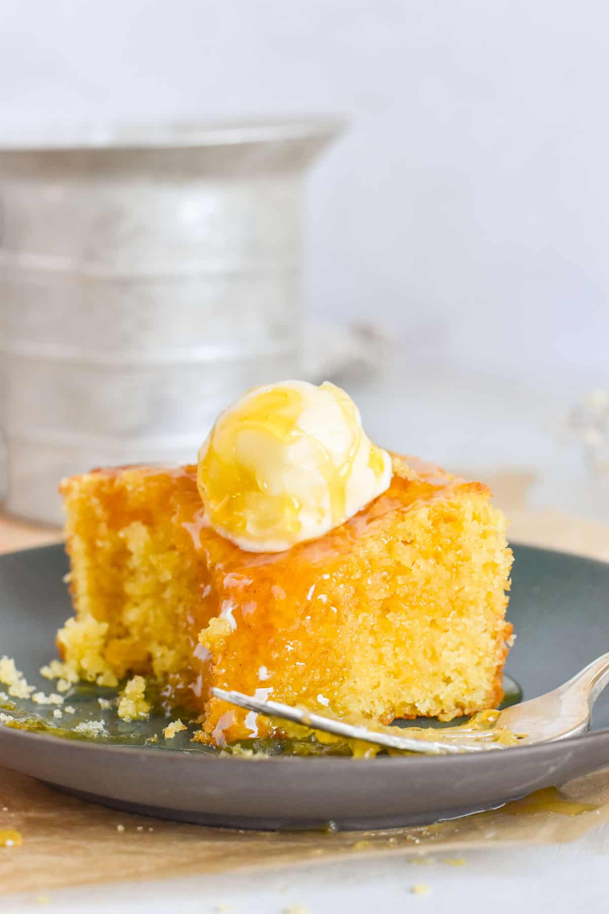 cornbread on plate with bite out of it.