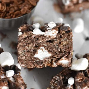 cocoa krispie square propped on other treat.
