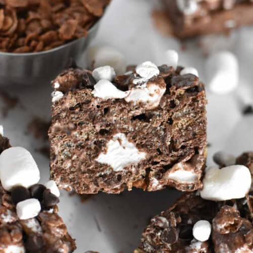 cocoa krispie square propped on other treat.