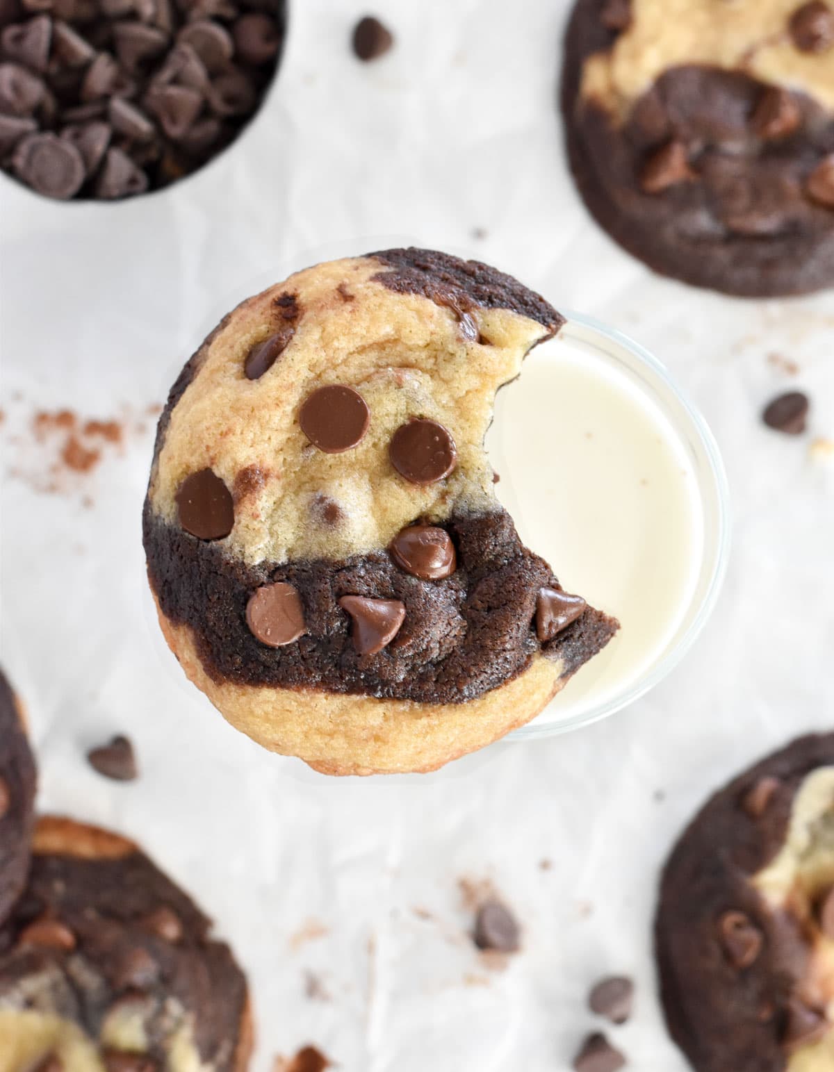 bitten cookie on glass of milk.