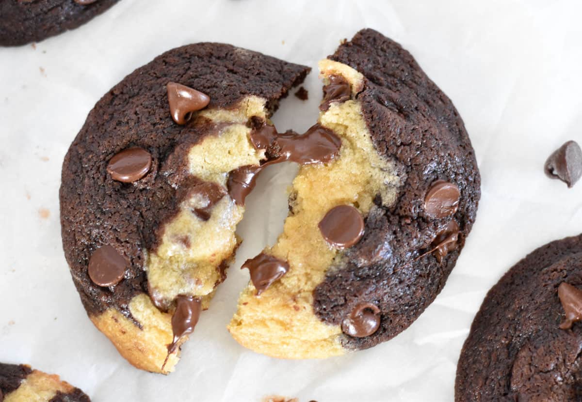 cookie broken in half with melty chocolate chips.